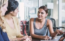 3 women talking and working